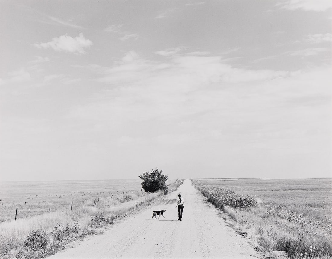 ROBERT ADAMS (1937- ) Walking, South of Grover, Colorado. 1973.: ROBERT ADAMS (1937- ) Walking, South of Grover, Colorado. 1973. Silver print, the image measuring 7¼x9½ inches (18.4x24.1 cm.), the mount 14x15½ inches (35.6x39.4 cm.), with Adams' hand