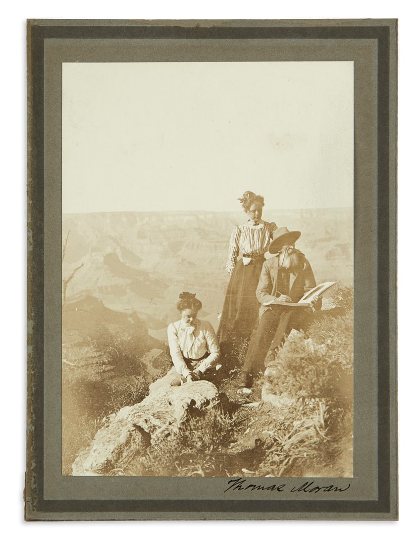 (WEST--ARIZONA.) Pair of photographs of Thomas Moran at the Grand Canyon, one of them signed.: (WEST--ARIZONA.) Pair of photographs of Thomas Moran at the Grand Canyon, one of them signed. Silver prints, each about 4½ x 6½ inches, on original plain mounts, captioned in mount, one
