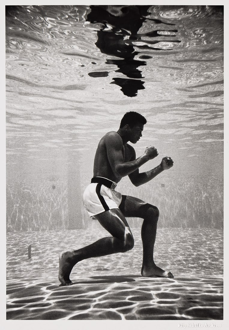 FLIP SCHULKE (1930-2008) Ali Underwater. 1961; printed later.: FLIP SCHULKE (1930-2008) Ali Underwater. 1961; printed later. Silver print, the image measuring 13x9 inches (33x23 cm.), the sheet slightly larger, with the Flip Schulke Archive blind stamp on recto,