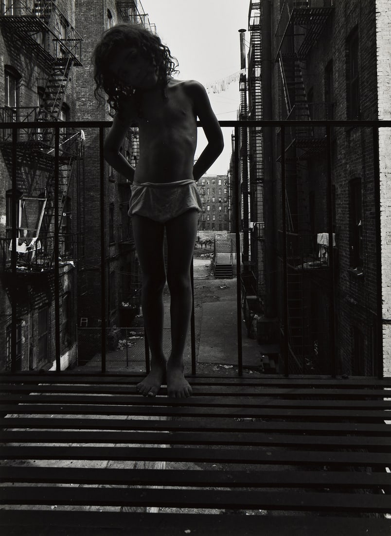 BRUCE DAVIDSON (1933- ) East 100th Street (child on fire escape). 1967-68; printed 1970s.: BRUCE DAVIDSON (1933- ) East 100th Street (child on fire escape). 1967-68; printed 1970s. Silver print, the image measuring 11⅛x8¼ inches (28.3x21 cm.), the sheet 14x11 inches (35.6x27.9 cm