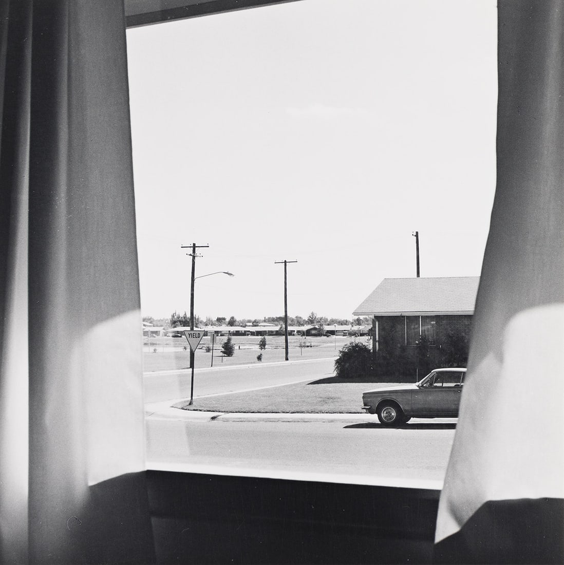 ROBERT ADAMS (1937- ) Out a Front Window, Longmont, Colorado, from The New West. 1968-71.: ROBERT ADAMS (1937- ) Out a Front Window, Longmont, Colorado, from The New West. 1968-71. Silver print, the image measuring 6 inches (15.2 cm.) square, the mount 13x11 inches (33x27.9 cm.), with Adams