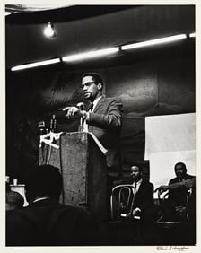 (MALCOLM X.) Robert L. Haggins, photographer. Malcolm X at the podium.