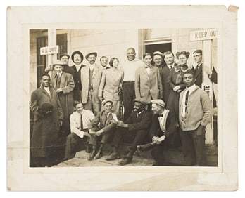 (SPORTS--BOXING.) Photograph of rifle-toting champion Jack Johnson with his entourage.