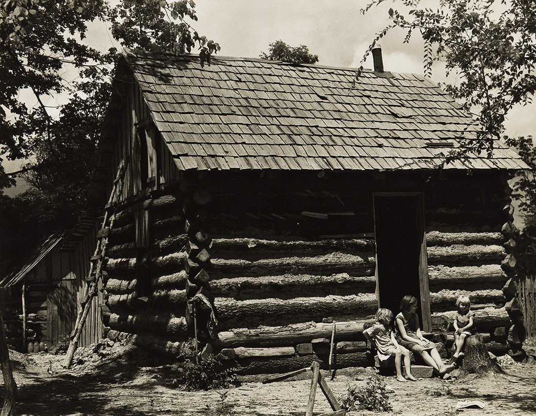 ARTHUR ROTHSTEIN (1915-1985) Family on the steps of their cabin. Circa 1937.: ARTHUR ROTHSTEIN (1915-1985) Family on the steps of their cabin. Circa 1937. Silver print, the image measuring 7⅜x9⅜ inches (18.7x23.8 cm.), the mount 13⅜x11 inches (34x27.9 cm.), wi