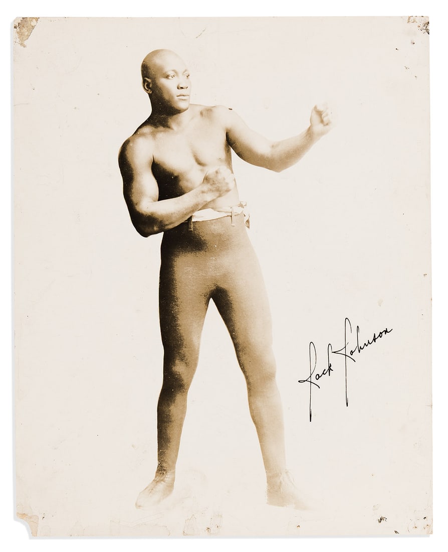 (SPORTS--BOXING.) Full-length portrait of heavyweight champion Jack Johnson.: (SPORTS--BOXING.) Full-length portrait of heavyweight champion Jack Johnson. Silver print, 10 x 8 inches, with facsimile signature in negative; minor wear with mount remnants and tack holes in corners