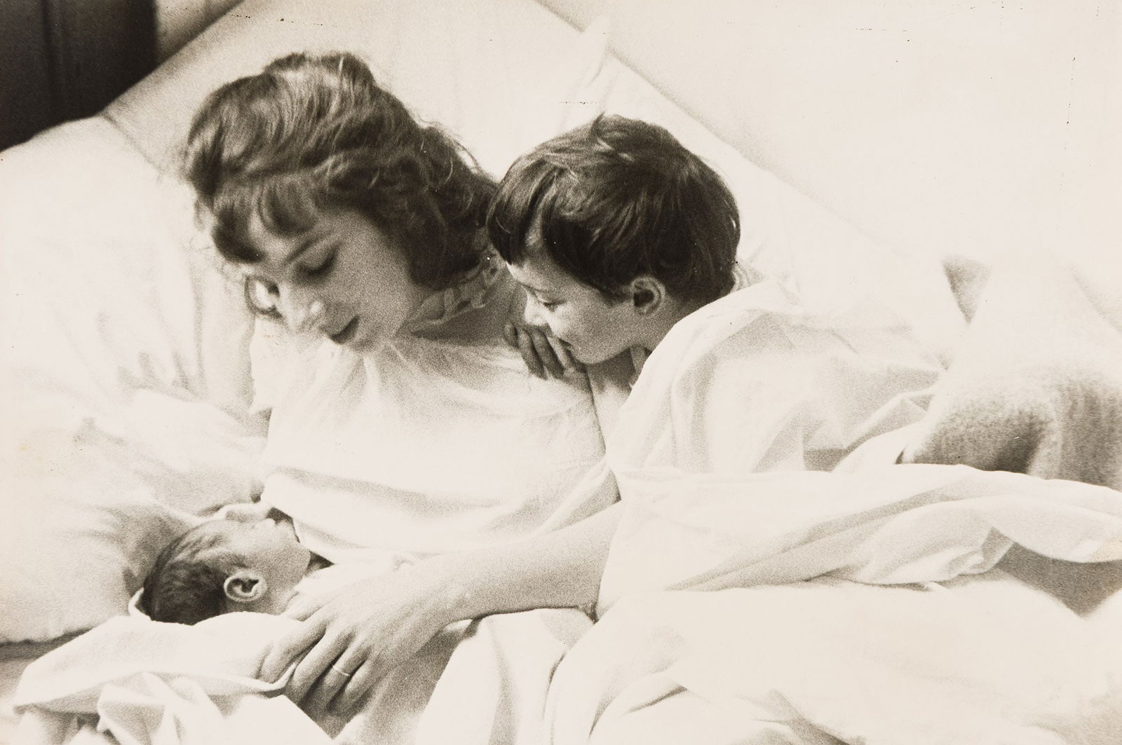 Robert Frank. Mary and Pablo watching newborn Andrea. Circa 1954.: Robert Frank1924-2019Mary and Pablo watching newborn Andrea. Circa 1954.Silver printWith Mary Frank's signature in pencil on verso.The image 7 1/4 x 11 in. (18.4 x 27.9 cm.), the sheet slightly larger