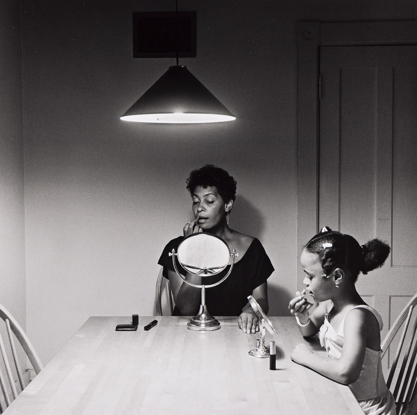 Carrie Mae Weems. Untitled, from the Kitchen Table Series. 1990; printed 1999.: Carrie Mae Weems1953-Untitled (Woman and Daughter with Makeup), from the Kitchen Table Series. 1990; printed 1999.Silver printWith Weems' signature and print date in pencil on verso.The image 7 1/2 in