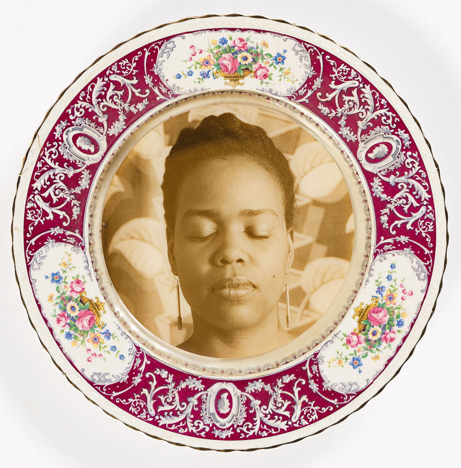 Carrie Mae Weems. Untitled (ceramic plate with a portrait of Saidiya Hartman). 1990.: Carrie Mae Weems1953-Untitled (ceramic plate with a portrait of Saidiya Hartman). 1990.Silver print embedded in resin on a patterned ceramic plateWith Weems' signature and date in ink on plate verso.T