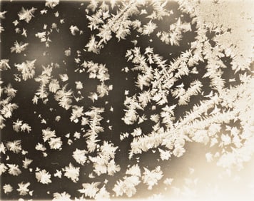 A suite of 8 microphotographs of elegant ice crystals. Circa 1920.