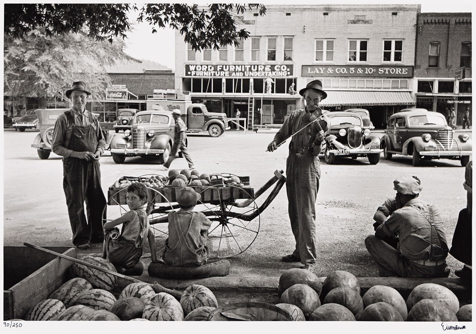 Alfred Eisenstaedt. Melon Salesman and Fiddler, Scott, Mississippi. 1936; printed circa 1990.: Alfred Eisenstaedt1898-1995Melon Salesman and Fiddler, Scott, Mississippi. 1936; printed circa 1990.Silver printWith Eisenstaedt's signature and edition notation 90/250 in ink on recto, and his credit