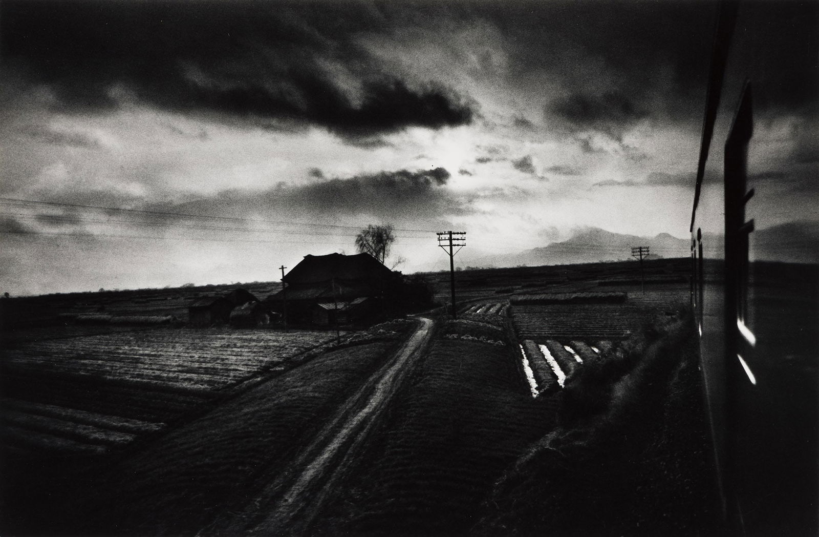 W. Eugene Smith. Landscape from a Moving Train, Japan. 1961; printed circa 1970.: W. Eugene Smith1918-1978Landscape from a Moving Train, Japan. 1961; printed circa 1970.Silver printWith Smith's signature in pencil on mount recto.The image 8 1/2 x 12 7/8 in. (21.6 x 32.7 cm.), the m