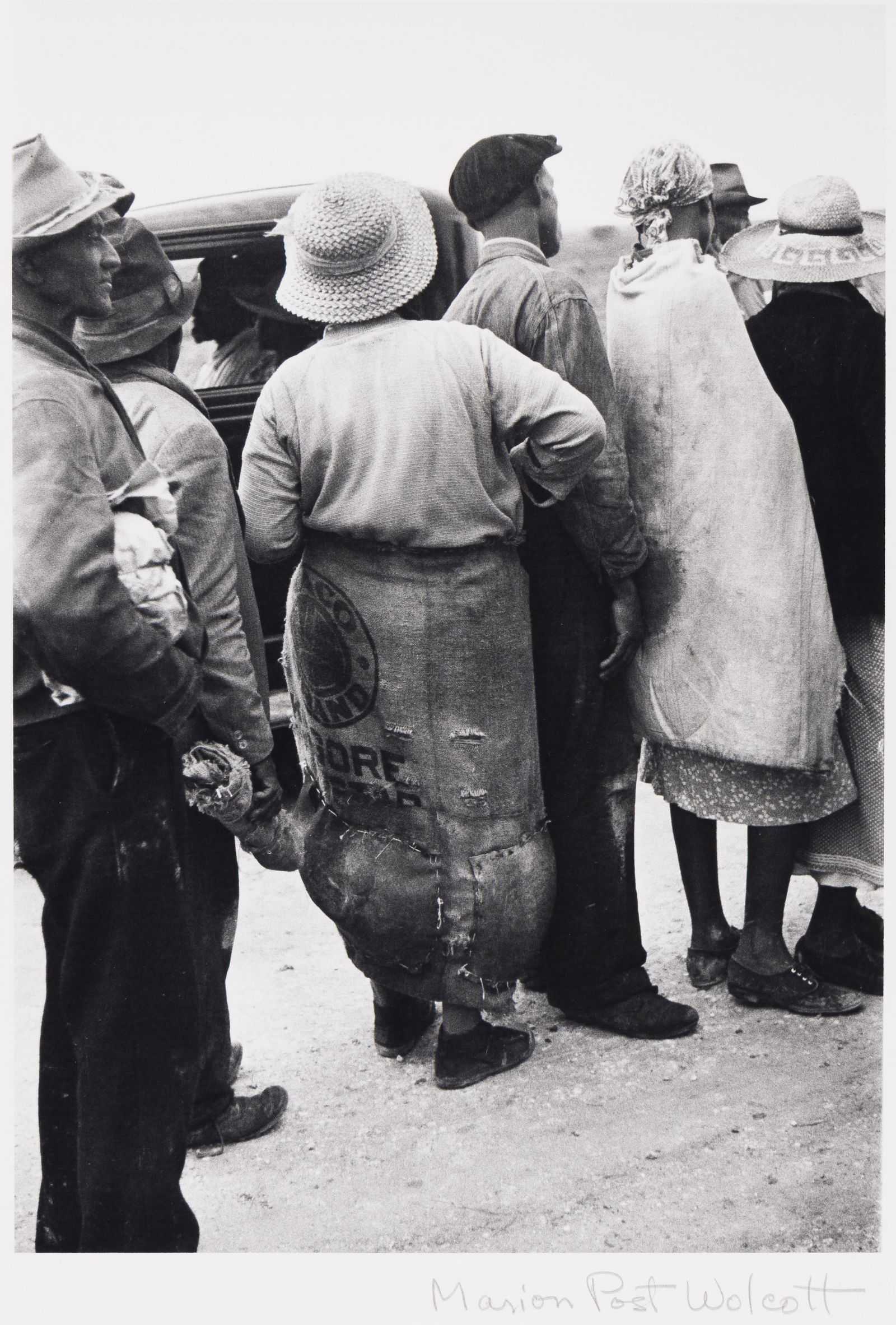 Marion Post Wolcott, Migrant vegetable pickers lined up behind truck in field to be paid off. Near: Marion Post Wolcott1910-1990Migrant vegetable pickers lined up behind truck in field to be paid off. Near Homestead, Florida. 1939; printed 1977.Selenium-toned silver print.With Wolcott's signature in