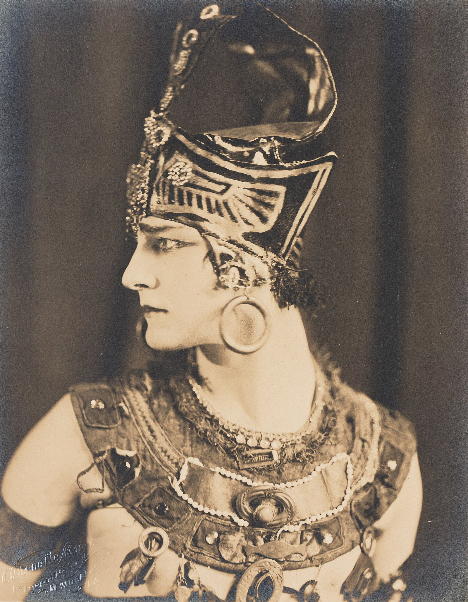 Portrait of the dancer, artist, and eventual gay icon Paul Swan (1883-1972) in costume. 1926.: Portrait of the dancer, artist, and eventual gay icon Paul Swan (1883-1972) in costume. 1926.Silver printWith the C. Bennette Moore studio blind stamp on recto.The image 9 1/8 x 7 1/8 in. (23.2 x 18.1