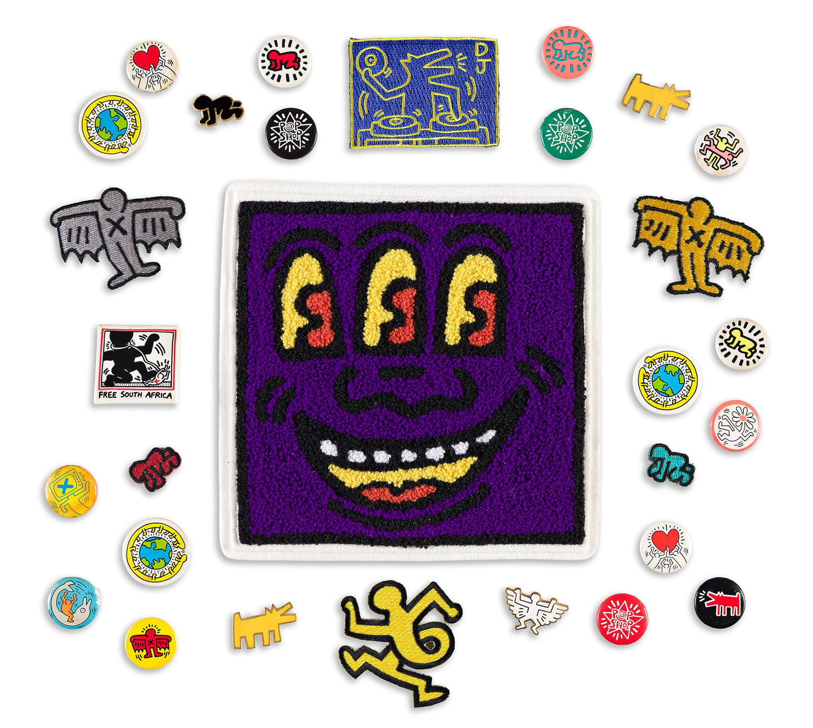 Keith Haring, [Keith Haring Merchandise] Group of pins, badges, and patches from the Pop Shop.: Keith Haring1958-1990[Keith Haring Merchandise] Group of pins, badges, and patches from the Pop Shop.One large "Three-Eyed Monster" tufted patch (7x7 inches), six woven patches (various sizes), four e