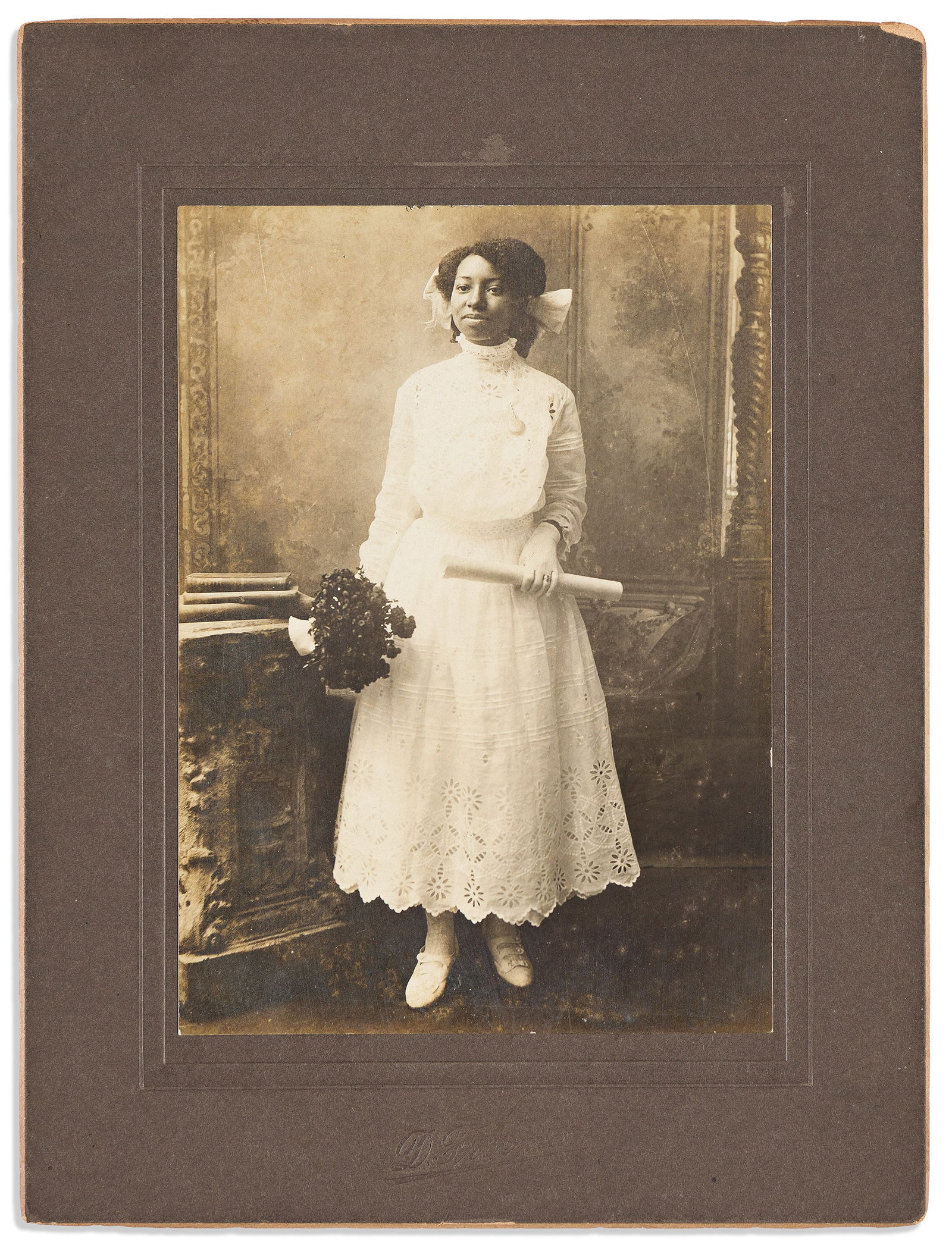 (PHOTOGRAPHY.) Daniel Freeman. Portrait of a young woman holding what may be a diploma. Washington, (1 of 1)