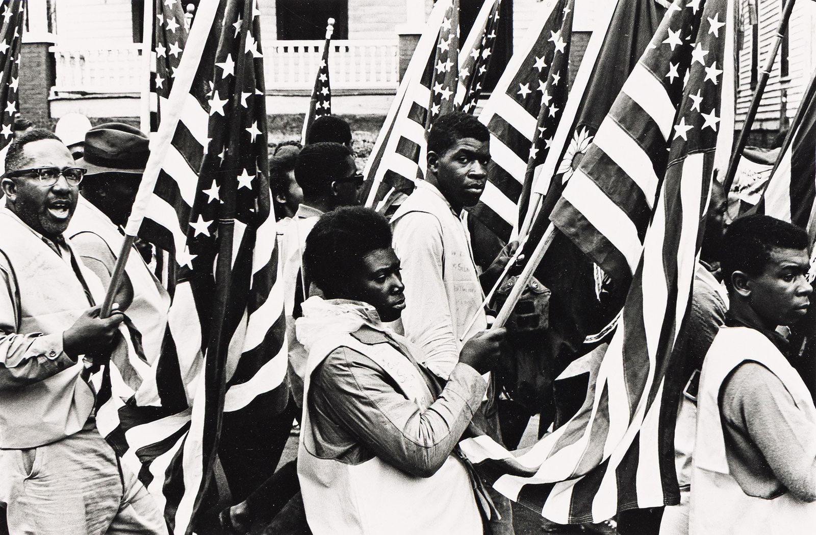 Robert A. Sengstacke (1943-2017), Selma to Montgomery Marchers with Flags, 1965.: Robert A. Sengstacke (1943-2017) Selma to Montgomery Marchers with Flags. Vintage gelatin silver print, 1965. Signed in pencil, verso. 5 1/2 x 8 1/2 in. (14 x 21.6 cm.), Frame: 15 1/2 x 19 1/2 in.