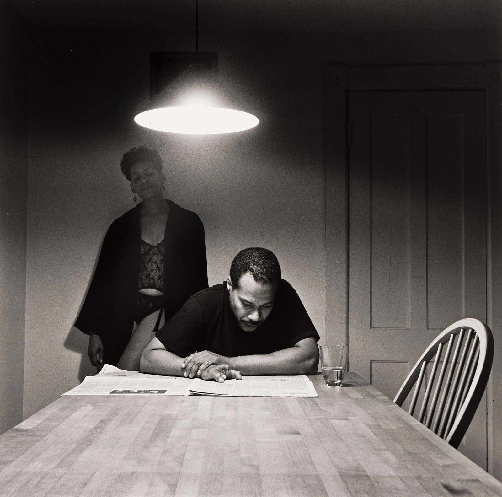 Carrie Mae Weems (b. 1953), Untitled (Man Reading Newspaper), 1990/1999, printed 2015.: Carrie Mae Weems (b. 1953) Untitled (Man Reading Newspaper). Silver gelatin print, 1990/1999, printed 2015. Signed, dated and numbered 23/25 in ink, verso. From the collector's edition of Kitchen Tabl