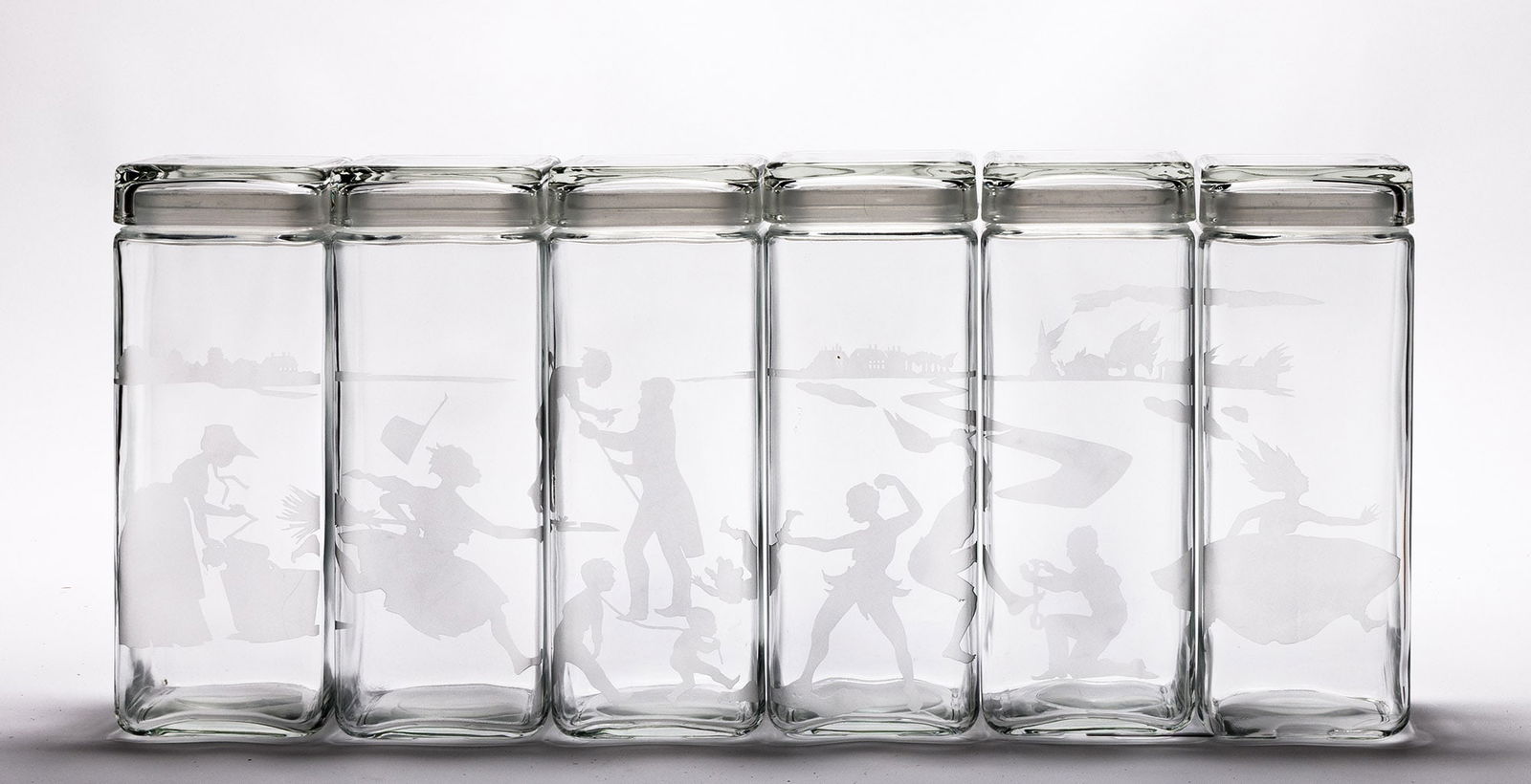 Kara Walker (b. 1969), Canisters, 1997.: Kara Walker (b. 1969) Canisters. Set of six glass sculptures with sand etching, 1997. Edition of 100. Fabricated by National Engravers, Naperville, OH. Published by The Renaissance Society, University