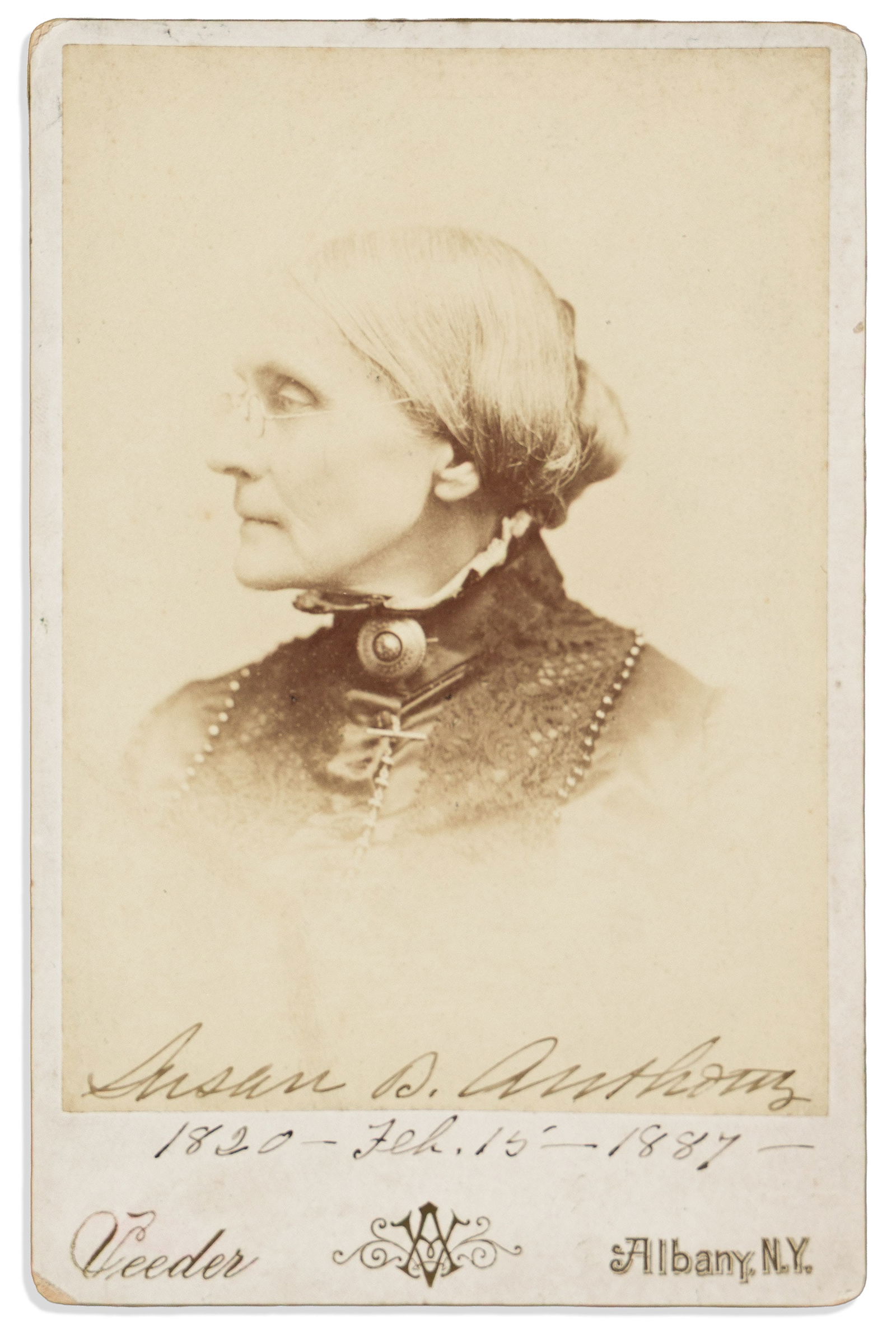 Susan B. Anthony. Photograph Signed and dated, "1820 -- Feb. 15 -- 1887,": Susan B. Anthony Photograph Signed and dated, "1820 -- Feb. 15 -- 1887," cabinet card vignetted bust portrait by Veeder, showing her in profile. Signed in the image at lower edge, and continuing onto