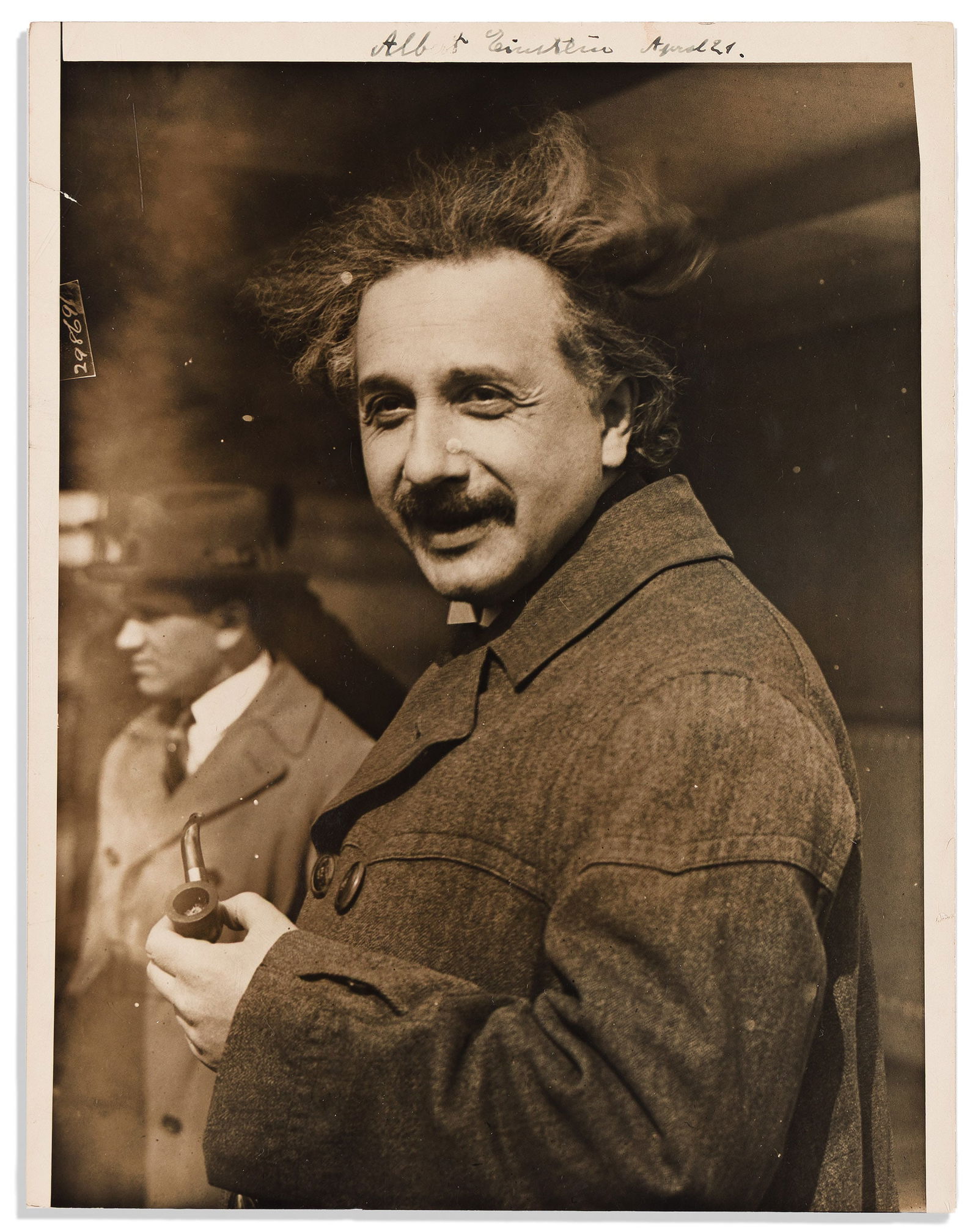 (Nobel Laureates--Physics.) Albert Einstein. Photograph dated and Signed, "Albert Einstein April: Albert Einstein Photograph dated and Signed, "Albert Einstein April 21," half-length portrait by Underwood & Underwood, showing him in ¾-view while speaking and holding his pipe. Signed