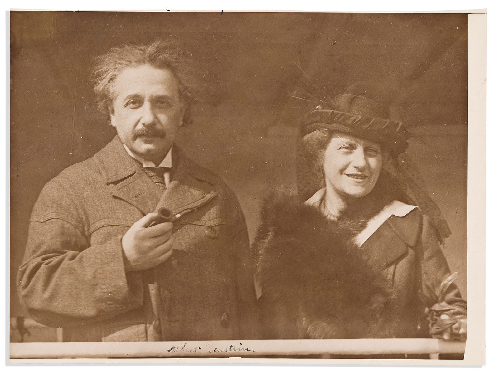 (Nobel Laureates--Physics.) Albert Einstein. Photograph Signed: Albert Einstein Photograph Signed, half-length portrait by Underwood & Underwood showing him standing with his wife Elsa aboard the SS Rotterdam in April, 1921. Signed in the image, lower cen