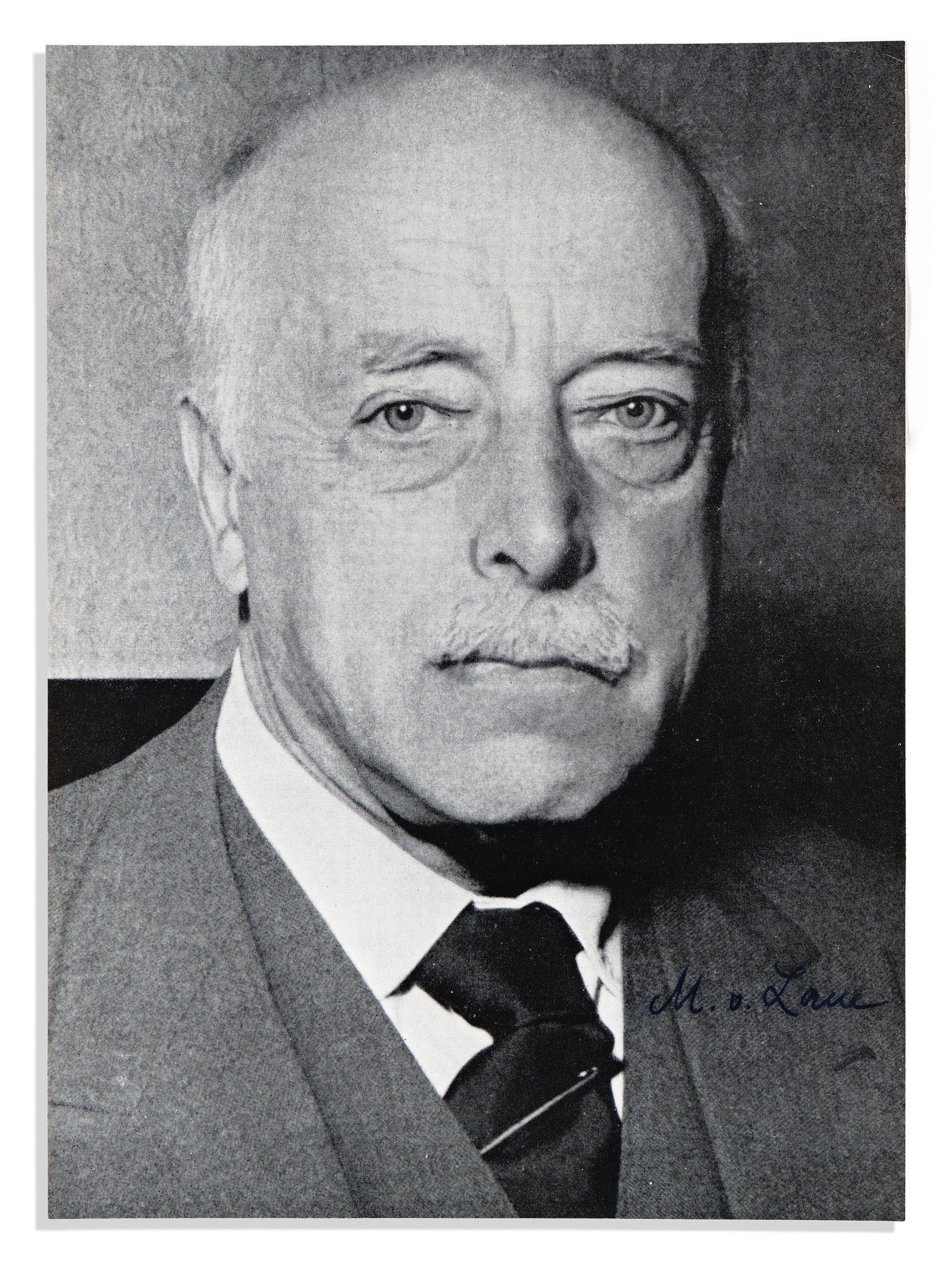 (Nobel Laureates--Physics.) Max von Laue. Photograph Signed, "M.v. Laue,": Max von Laue Photograph Signed, "M.v. Laue," bust portrait, likely clipped from a magazine, showing him looking into the camera. Signed in the image at lower right. 7¼x5¼ inches; mounted to