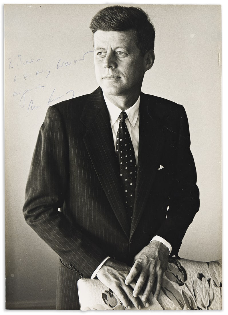 John F. Kennedy. Photograph Signed and Inscribed, "To Bill / with my warmest / regards, / John: John F. Kennedy Photograph Signed and Inscribed, "To Bill / with my warmest / regards, / John Kennedy," half-length portrait by Jacques Lowe, showing him holding the back of a chair and looking to one