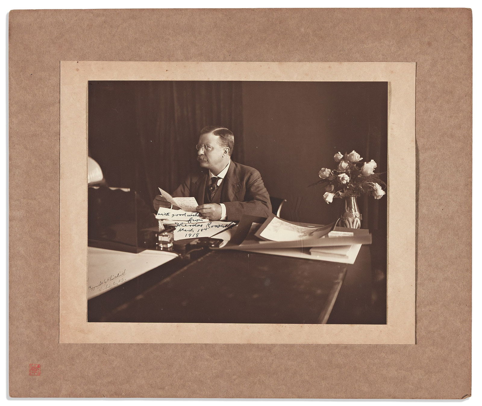 Theodore Roosevelt. Photograph Signed and Inscribed, "with good wishes,": Theodore Roosevelt Photograph Signed and Inscribed, "with good wishes," half-length portrait by Barnett McFee Clinedinst, showing him behind his desk. Inscribed in the image at center. Additionally si