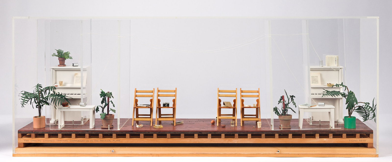 Roland Reiss (1929-2020), The Dancing Lessons: Spiritual Communication on the Physical Plane, 1977.: Roland Reiss (1929-2020) The Dancing Lessons: Spiritual Communication on the Physical Plane. Mixed-media diorama in a Lucite case, 1977. Signed and titled in pencil, lower edge. 36 3/8 x 7 7/8 x 14 in