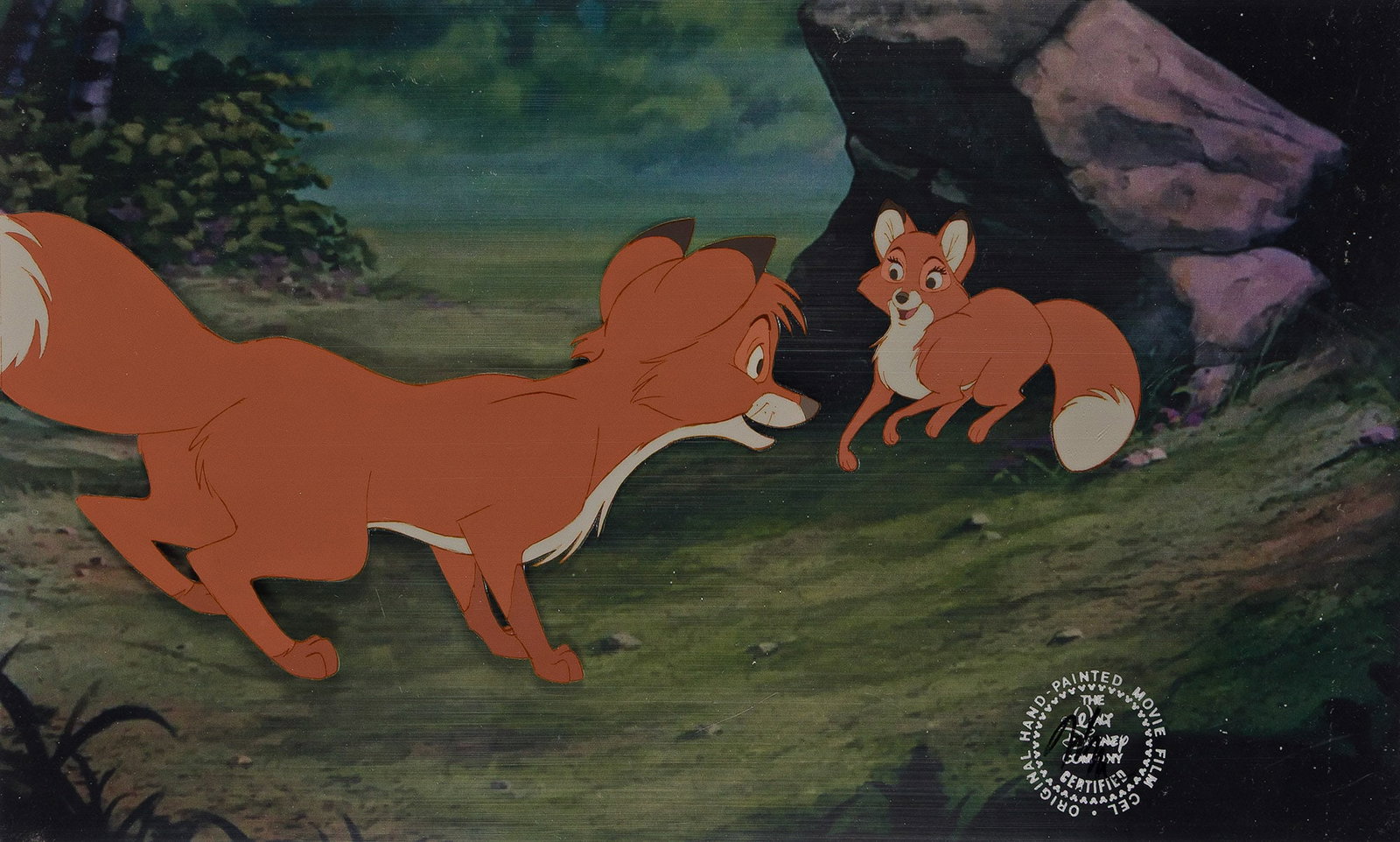 Walt Disney Studios, The Fox and the Hound, Tod and Vixie animation cel setup. 1981.: Walt Disney Studios The Fox and the Hound, Tod and Vixie animation cel setup. 1981. The official Disney seal is present at the bottom right corner of the setup. A print background of the foxes' den is