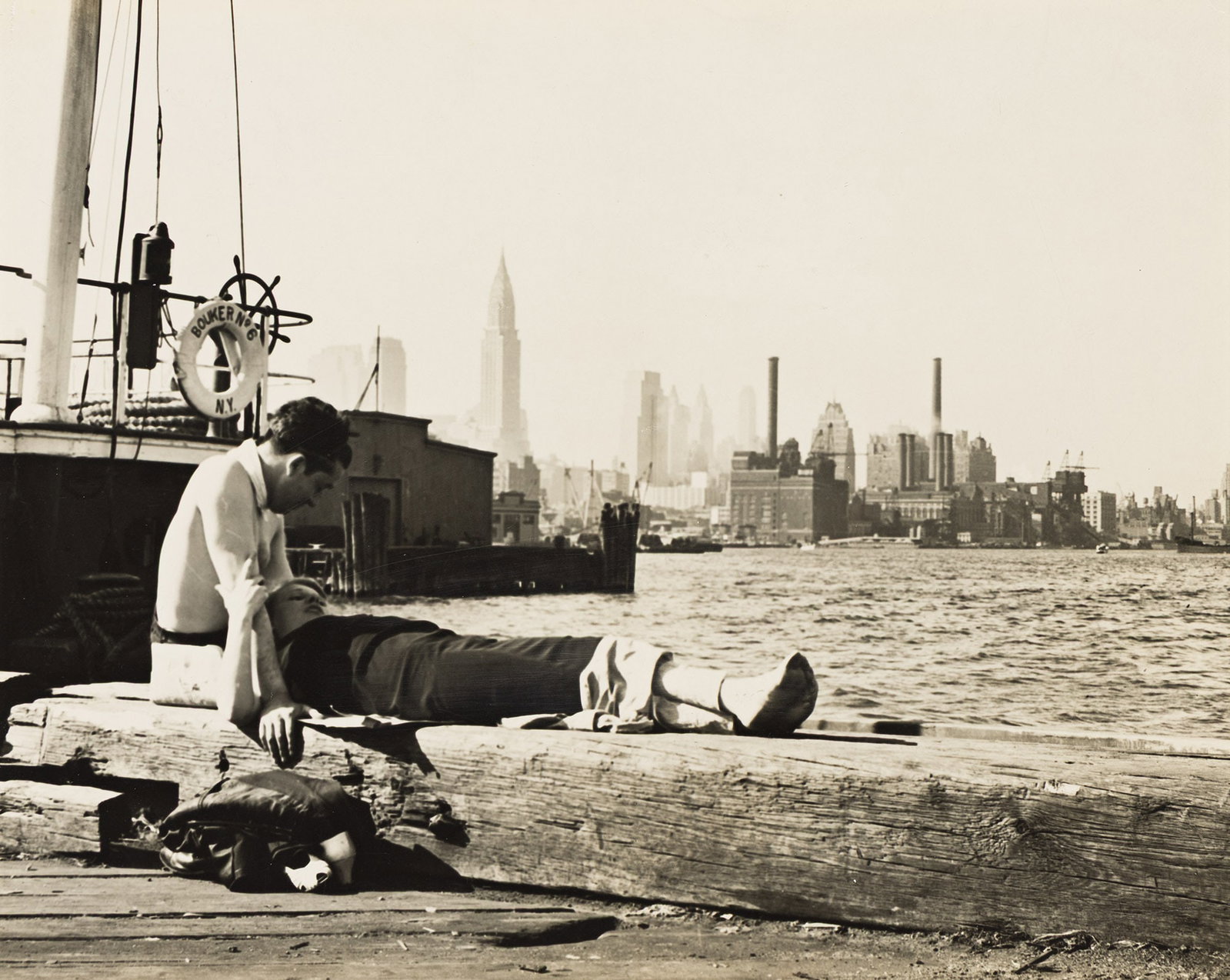 Edward Schwartz, Love and Romance in N.Y. City (East River Pier about East 22nd St.), June 1939.: Edward Schwartz 1906-2005 Love and Romance in N.Y. City (East River Pier about East 22nd St.). June 1939. Silver print. With Schwartz's title and negative date in ink, and his credit stamp with the lo