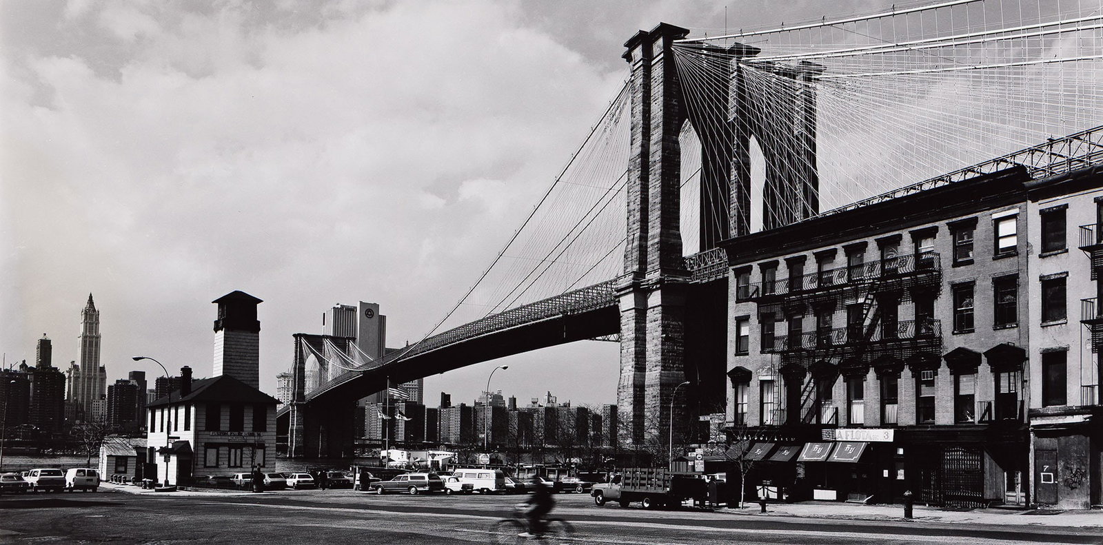 George Forss, Brooklyn Bridge from Front Street, 1986.: George Forss 1941-2021 Brooklyn Bridge from Front Street. 1986. Silver print. With Forss' signature, title, and date with a stylus on print recto, and again in pencil on the overmat. The image 11 7/8 