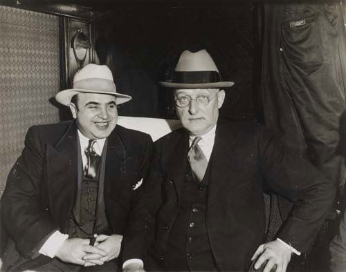 (CRIME) Group of 64 photographs of criminals a: (CRIME) Group of 64 photographs of criminals and crime scenes, including Al Capone, Charles "Lucky" Luciano, John Dillinger, "Pretty Boy" Floyd, and many others. Silver prints, 7 1/2x5 1/2 to 8 1/2x6