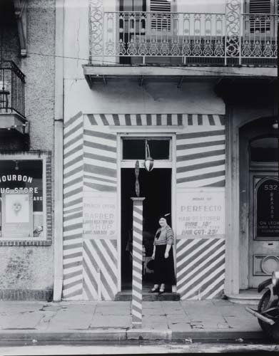 EVANS, WALKER (1903-1975) Untitled (Woman outs: EVANS, WALKER (1903-1975) Untitled (Woman outside barber shop, New Orleans). Silver print, 9 1/2x7 1/2 inches (24.3x19 cm.), with a Walker Evans Archive hand stamp on verso. 1936; printed 1950s-early