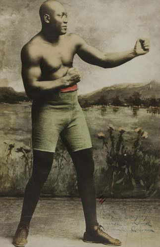 (BOXING.) Photographic Poster of Jack Johnson,: INSCRIBED BY JOHNSON TO DEMPSEY. (BOXING.) Photographic Poster of Jack Johnson, 27x17 inches. From a tinted photograph; a few almost unnoticeable creases; framed. Np, circa 1919-25 inscribed to jac