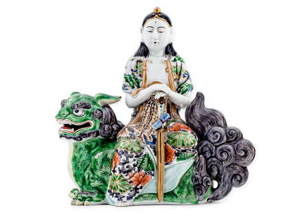 Guanin on the Buddha lion, China 18th c.: Guanin on the Buddha lion, China 18th c. porcelain, enamel paint, minor defects of enamel height: 25.5 cm