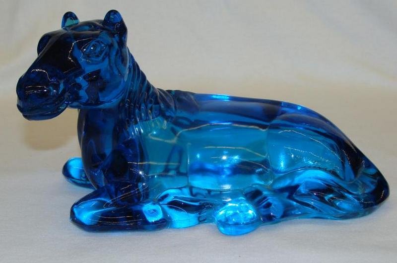 Blue Glass Statue of Horse Lying Down. Auction Estimate: Blue Glass Statue of Horse Lying Down. Auction Estimate $50-100.