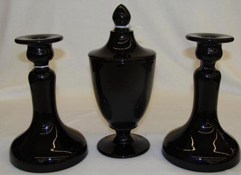3pcs Cambridge: Includes Ebony Glass Candlesticks and P: 3pcs Cambridge: Includes Ebony Glass Candlesticks and Pedestaled Covered Compote. Auction Estimate $50-100.