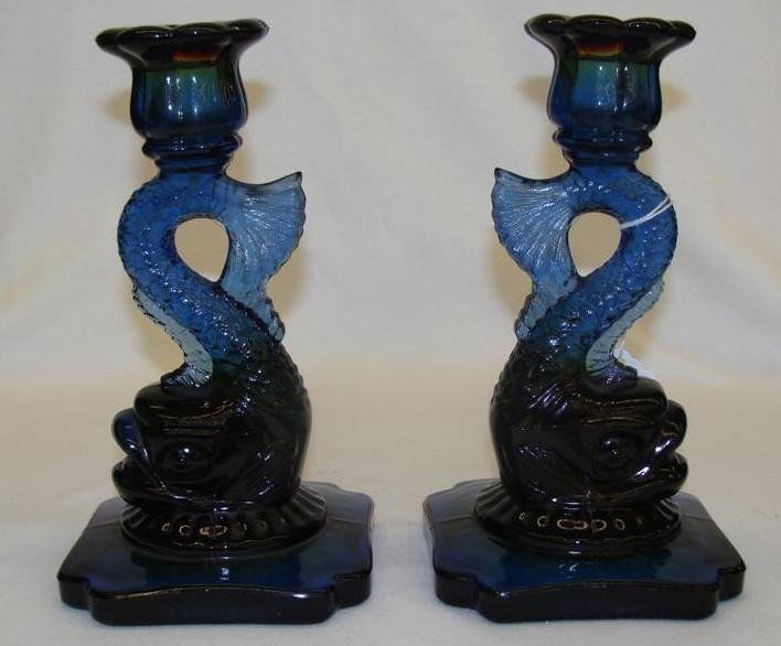 Pair of Viking Art Glass Dolphin Candlesticks with an A: Pair of Viking Art Glass Dolphin Candlesticks with an Amber Shaded to Blue Bottom. Auction Estimate $50-100.