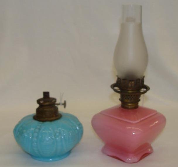 Two Antique Miniature Art Glass Oil Lamps; One is Light: Two Antique Miniature Art Glass Oil Lamps; One is Light Blue the other is Pink. Auction Estimate $100-200.