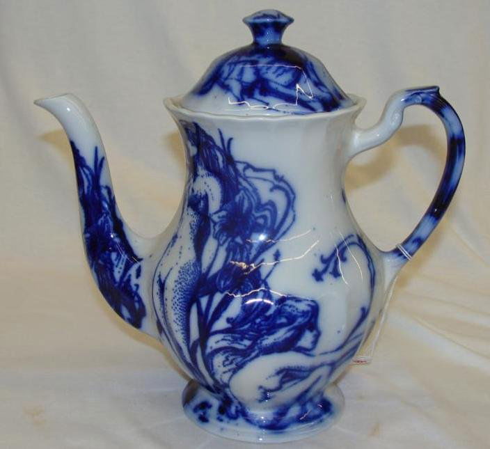 J & G Meakin Flow Blue Coffee Pot in a Classic White Pa: J & G Meakin Flow Blue Coffee Pot in a Classic White Pattern. Note: Stress Mark on Bottom. Auction Estimate $50- 100.