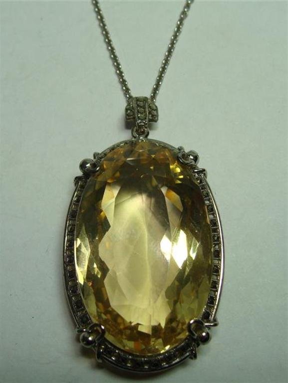 Art Deco Necklace with Large Lemon Citrine Pendant: Art Deco Necklace with Large Lemon Citrine Pendant Framed in Sterling with Marcasites with an 18" sterling silver Chain, Pendant is 1.5" in Length. Auction Estimate $100-200.