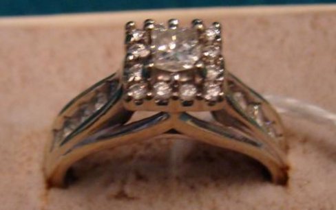 14K White Gold Diamond Ring; Beautiful Princess Cut: 14K White Gold Diamond Ring; Beautiful Princess Cut Center Stone in Raised Prong Setting with Round Diamonds Surrounding; Shank on Both Sides is Accented with 5 Round Diamonds; Approximately 1Ctw. Siz