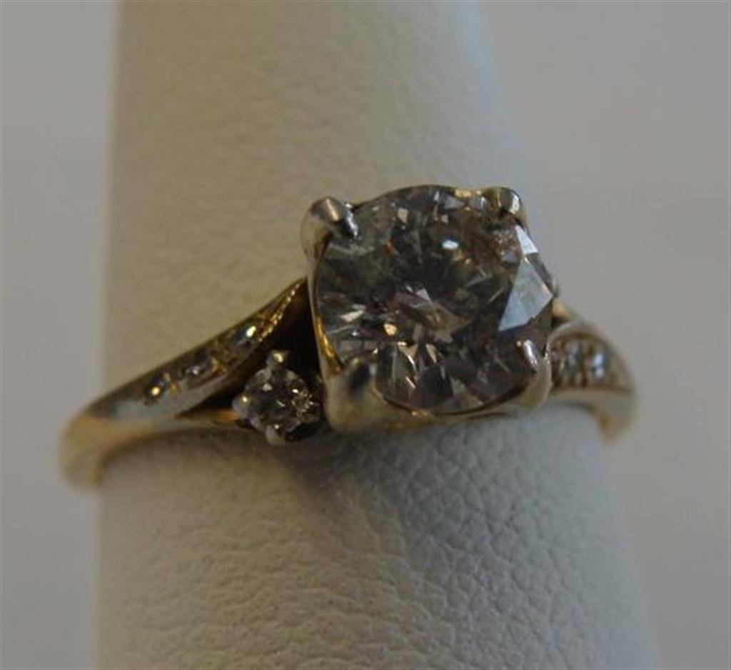 14K Yellow Gold Diamond Ring; Approx 1ct Brilliant Cut: 14K Yellow Gold Diamond Ring; Approx 1ct Brilliant Cut Center Stone with 4 Diamonds on Each Side. Size 6.5; 2.1 Grams. Auction Estimate $1000- 1500.