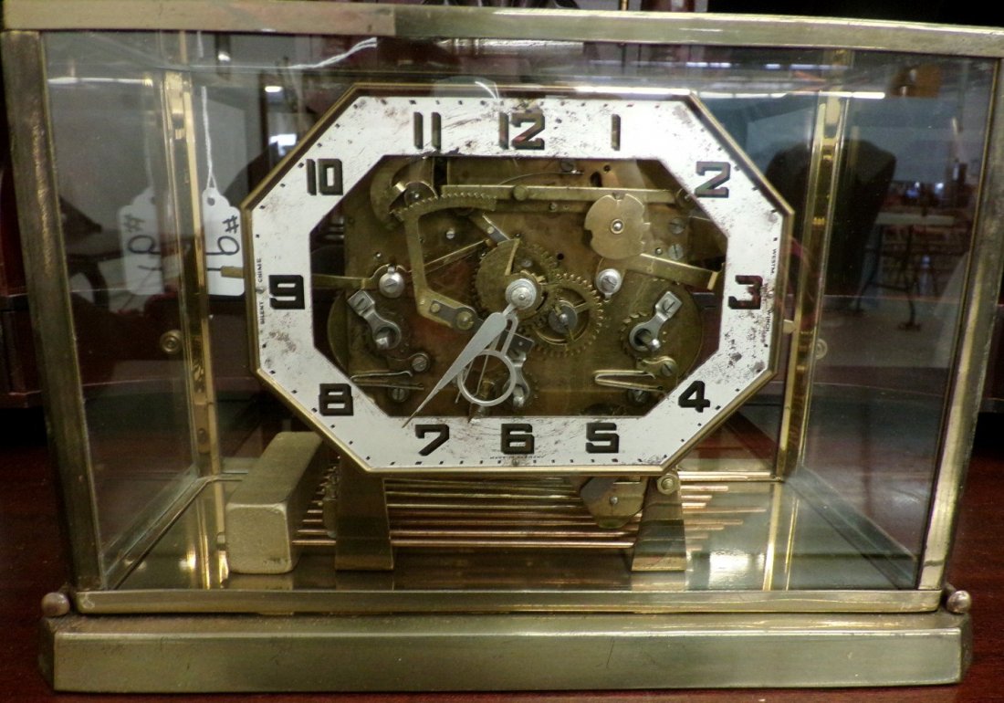 Art Deco Brass & Glass Cased Anniversary Clock with: Art Deco Brass & Glass Cased Anniversary Clock with German Movement, Key Wind, Working Condition. Auction Estimate $400-600.