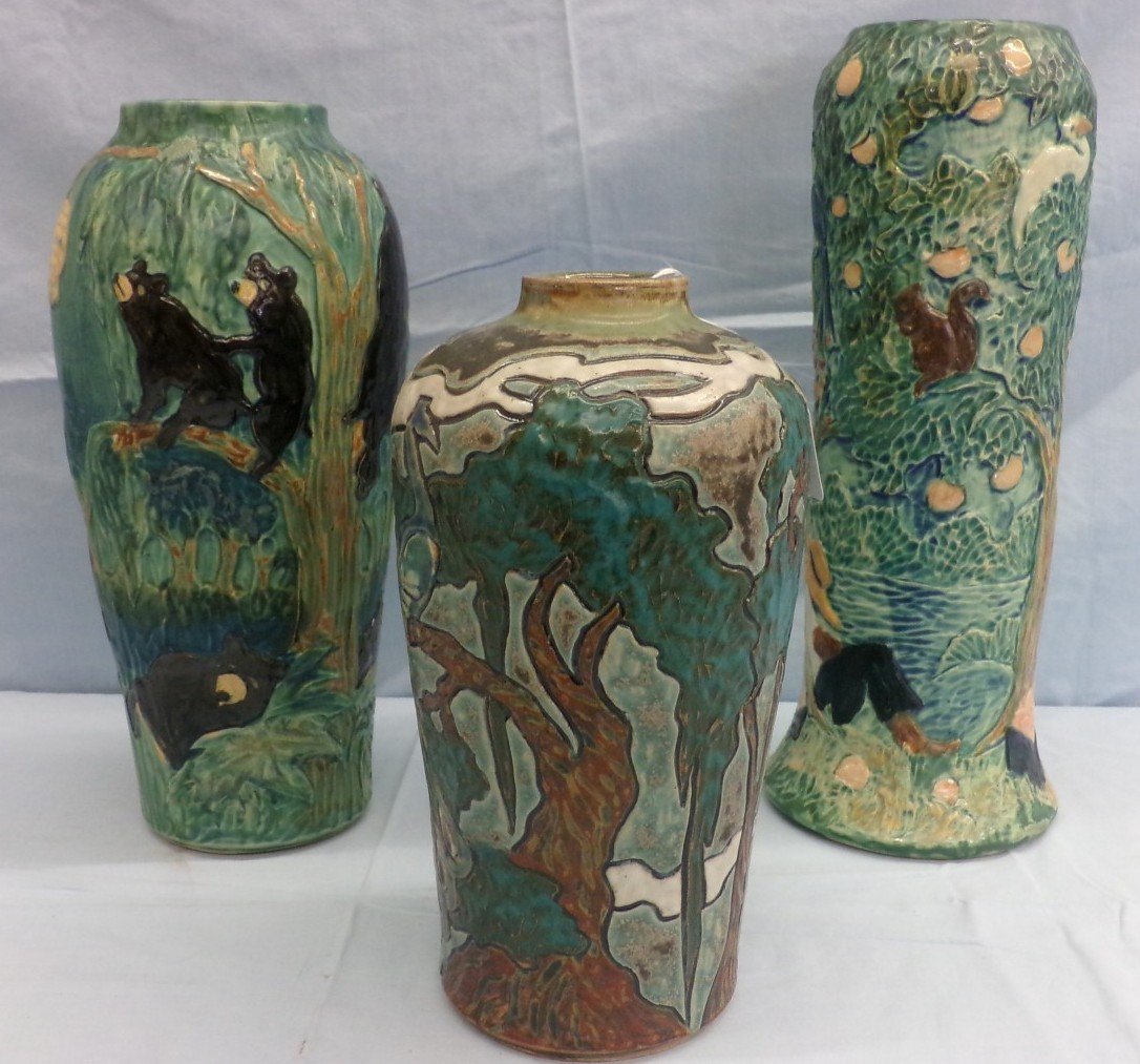 3pcs of Florida Faience Art Pottery; Vases, Woman in: 3pcs of Florida Faience Art Pottery; Vases, Woman in Orange Grove, Peacock Scene & Bears in Trees After a Beehive All are Artist Signed Cushman. Auction Estimate $200-400.