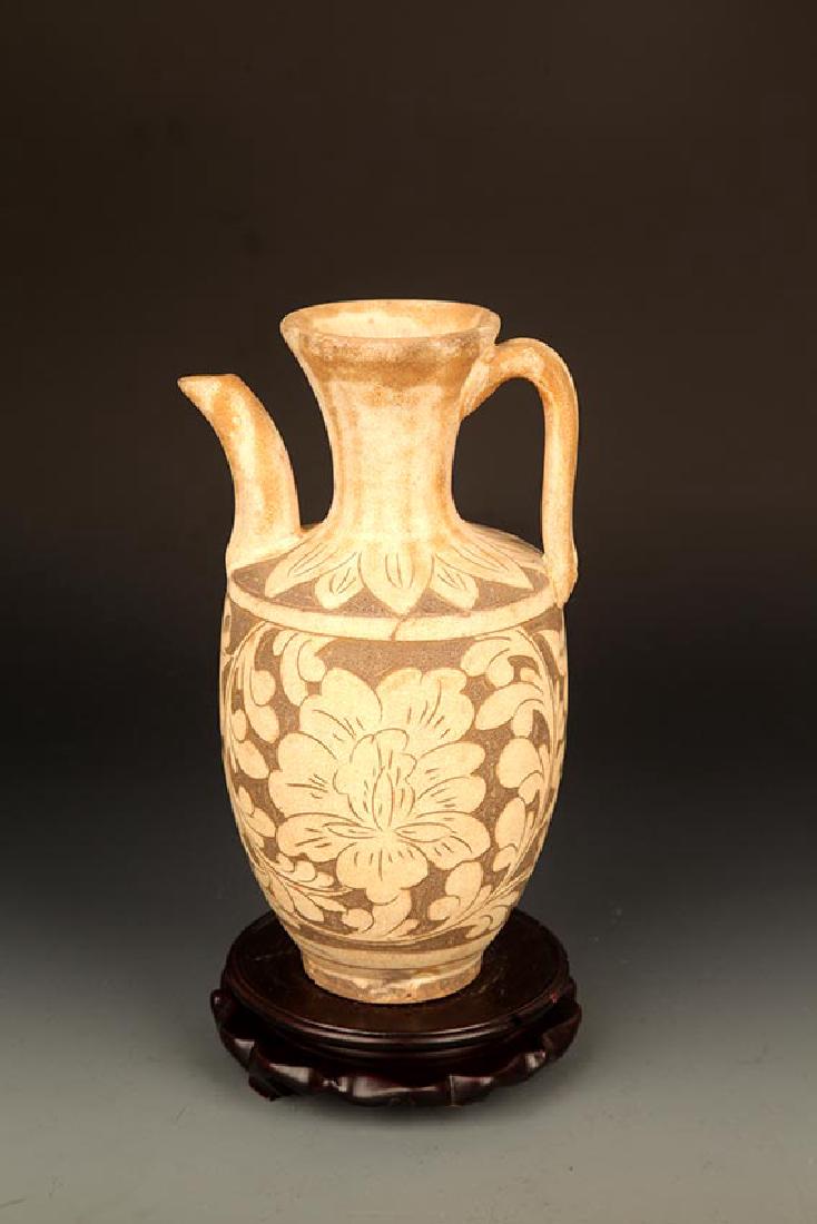 A "CI ZHOU YAO" FLOWER CARVING WATER BOTTLE: Song Dynasty, High: 9.75 inch; Diameter: 3.0 inch; Width: 5.5 inch