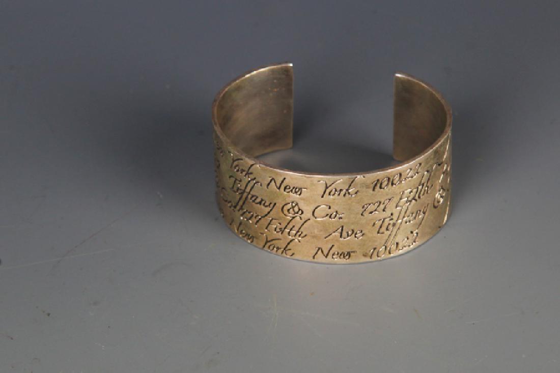 A FINELY CARVED SILVER PLATED BANGLE (1 of 3)