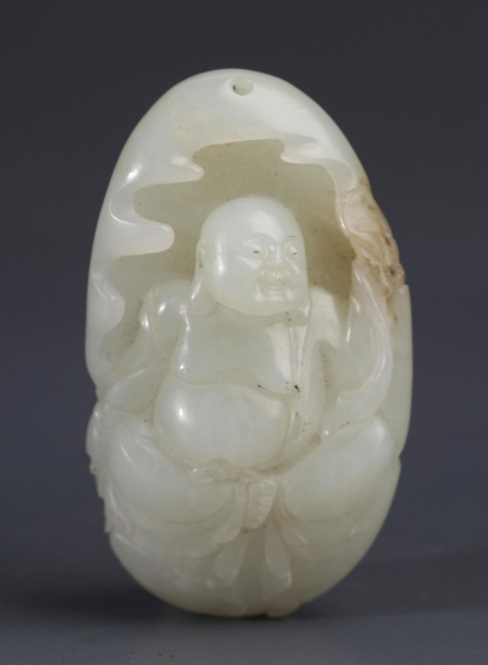 A FINELY CARVED WHITE JADE PENDANT FIGURE OF MAITREYA (1 of 9)