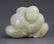 A WHITE JADE PENDANT FIGURE OF "LUCKY BOY"